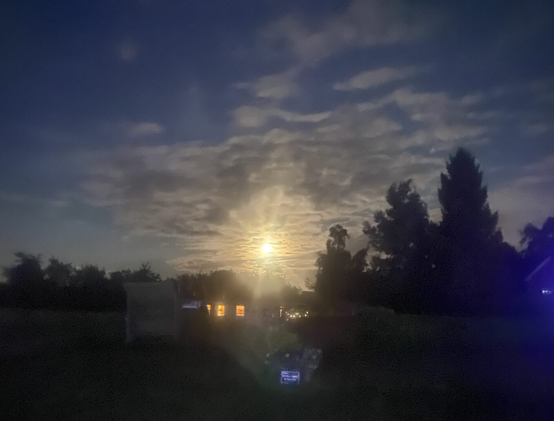 A bright moon shining bright over the campsite