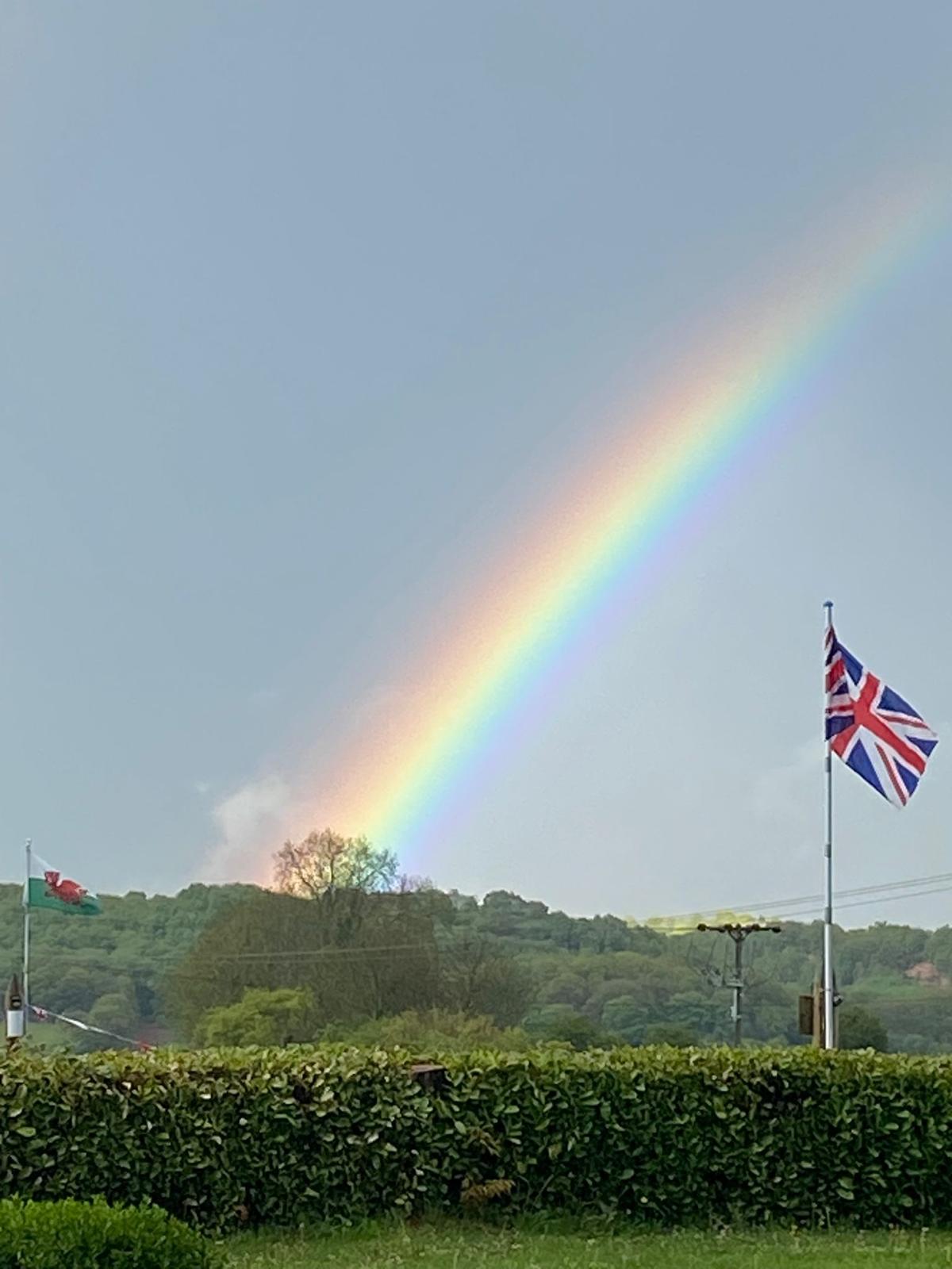 A RAINBOW SPREADS OVER THE PARK