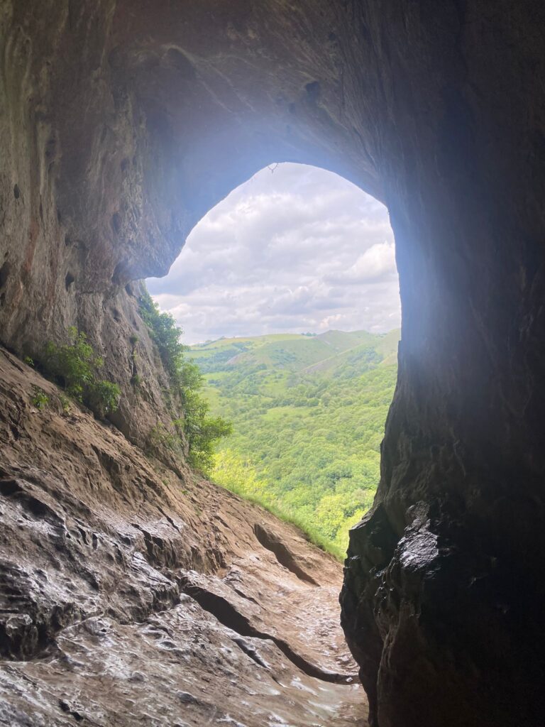 Daylight is shining into a large open cave
