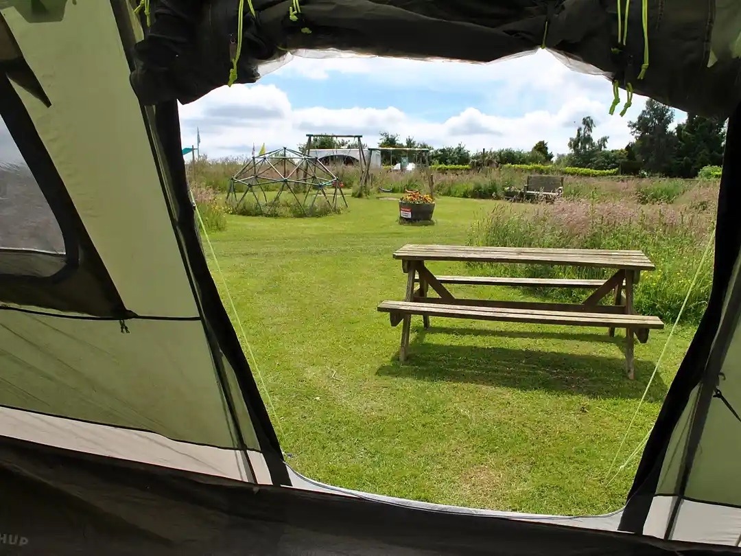View from a tent opening looking out towards the campsite