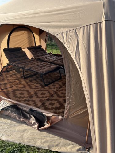 2 beds can been seen inside a star tent