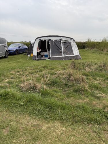 A tent set up on a spacious fully serviced pitch